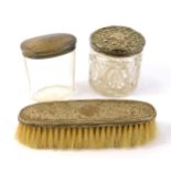 An Edward VIII moulded glass toilet jar, with a silver lid, embossed with flowers and scrolling