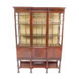 An Edwardian Chinese Chippendale style flame mahogany break front display cabinet, the outswept