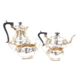 An Edward VII silver four piece tea set, of lobed and fluted form, raised on four bun feet,