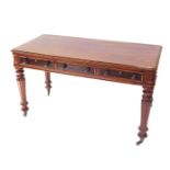 A Victorian style mahogany library table, with three frieze drawers, raised on turned and fluted
