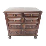 A 17thC panelled oak chest, of two short and three long graduated drawers, with moulded top, fielded