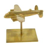A cast brass model of a Lancaster bomber, with spike support on rectangular slab base, 11cm H.