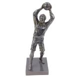 A lead figure of an early 20thC football goalkeeper, modelled standing poised to throw the ball,