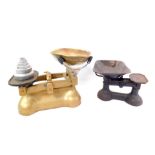 Gold painted cast iron Avery kitchen scales with weights, and a further set of cast iron scales.