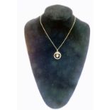 A 9ct gold blister pearl and amethyst circular pendant on chain, of circular reef and swag form, 3.