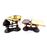 A cast iron kitchen scales, with a brass bowl and graduated cast iron and brass weights, and a