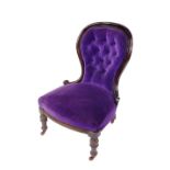 A Victorian mahogany balloon back nursing chair, upholstered in button back purple draylon and