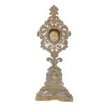 A Continental brass monstrance and reliquary, the monstrance of Baroque style with cast scrolling