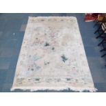 A Chinese rug decorated with a landscape, against a cream ground, 384cm x 275cm.