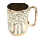 A Victorian silver semi fluted tankard, with embossed floral and scrolling foliate decoration,