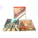 Three Beatles albums, comprising Sergeant Pepper, Abbey Road, and The Beatles double album
