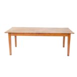 A pine country dining table, with a three plank top, raised on tapering square legs, 75cm H, 205cm