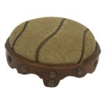 A small Victorian walnut hassock or footstool, with overstuffed circular seat and brass studded