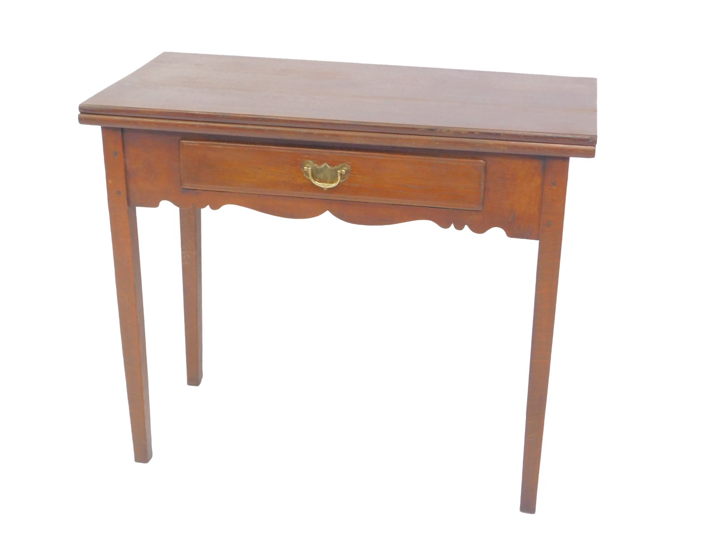 A George III oak fold over tea table, with a single frieze drawer and shaped apron raised on