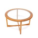 A late 20thC Nathan teak circular occasional table, with glass inset top, raised on turned legs,