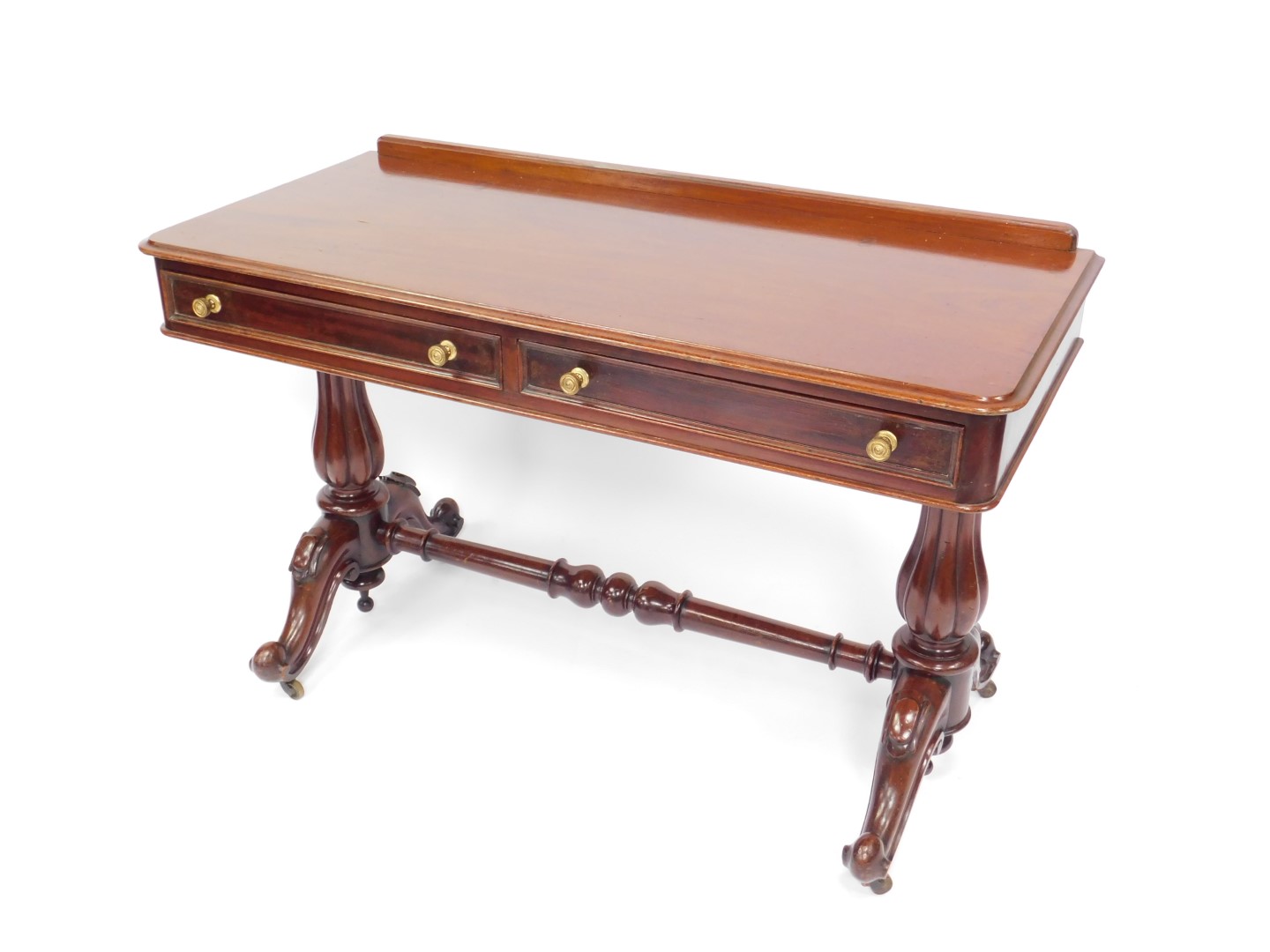 A Victorian mahogany side table, with two frieze drawers raised on turned fluted columns over