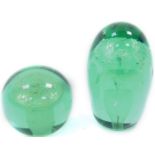 A Victorian green glass dump paperweight, decorated with a vase of two stepped flowers, 12cm H,