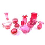 A group of Victorian cranberry glass, including jugs, bowls, pair of salts, and a vase, together