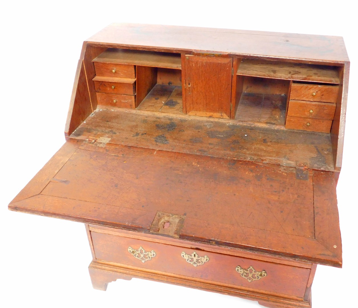 A George III oak bureau, the fall opening to reveal a central drawer flanked by recesses and six - Image 2 of 3