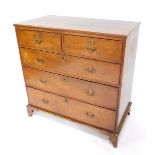 A George III oak chest of drawers, with two short over three long graduated drawers, raised on