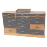 A Victorian pine tool chest, of fifteen graduated drawers, with cast iron handles, raised on a