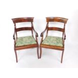 A pair of Regency flame mahogany carver dining chairs, with green floral pattern drop-in seats,