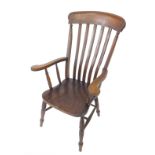 A Victorian oak and elm lath back kitchen chair, with solid saddle seat raised on ring turned
