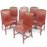 A set of seven George III style mahogany single dining chairs, with brass studded red leather