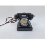 A 1950's black bakelite telephone, with chrome dial and 'Call Exchange' button, pull-out directory