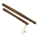 An oak police truncheon, 51cm L, and a further truncheon, 38cm L. (2)