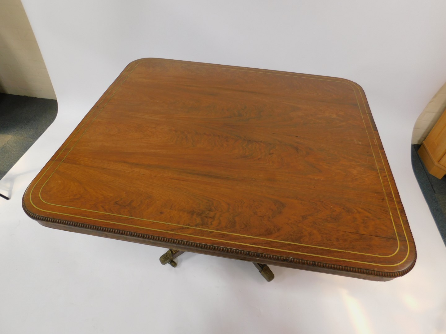 A Regency rosewood and brass inlaid tilt top breakfast table, the rectangular top with a gadrooned - Image 2 of 3