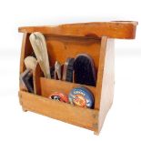 An early 20thC oak shoe polishing box, containing brushes and tins of polish, etc. 28cm H, 35cm W.