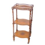 A Victorian rosewood three tier whatnot, of serpentine form with a galleried top, and two under