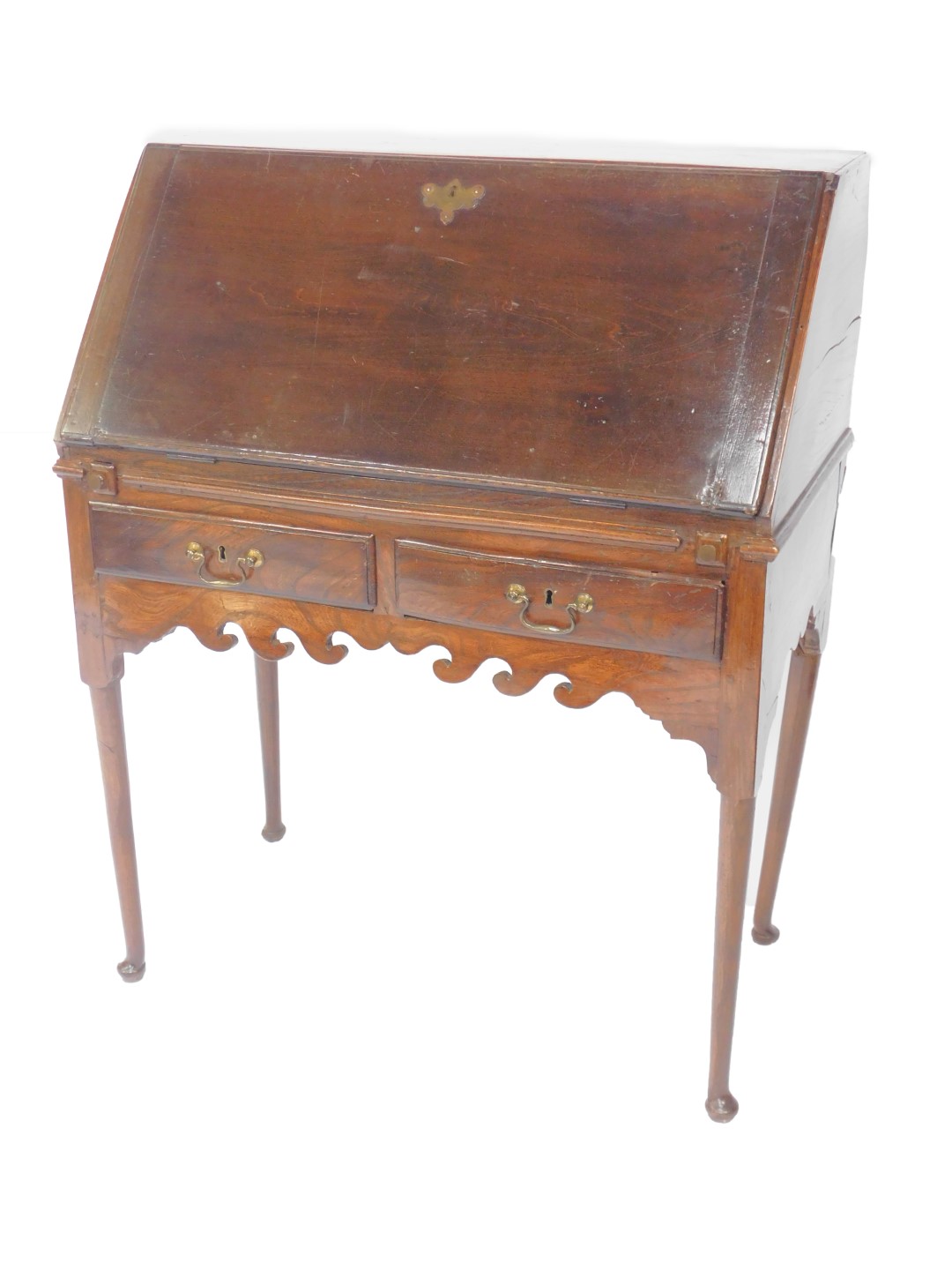 A George II oak bureau on stand, the fall flap opening to reveal an inlaid central door, flanked