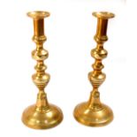 A pair of 19thC turned brass candlesticks, 30cm H.