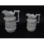 A pair of late 19thC Charles Meigh white stoneware graduated relief moulded jugs, decorated in the