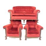 An early 20thC three piece lounge suite, comprising of a two seater settee and two armchairs each