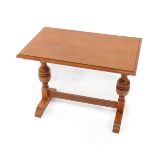 A 17thC style oak side table, with a rectangular top raised on cup and cover supports, and stepped