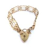 A 9ct gold four bar gate bracelet, with a heart shaped lock, 10g.