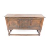 A Victorian 17thC style oak sideboard, the oak leaf carved frieze over two panelled doors