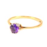 An amethyst solitaire ring, with round brilliant cut amethyst 4.8mm x 2.6mm, in a raised claw