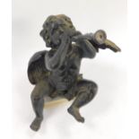A black painted resin shelf figure modelled as a cherub playing a trumpet, 26cm H.