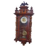 A late 19thC German walnut cased wall clock, circular brass dial, cast with thistles, enamel chapter