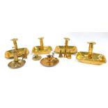 Four Georgian early 19thC brass chamber sticks, with sliding handle ejectors, three with snuffers,