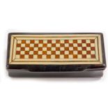 A Continental 19thC papier mache snuff box, with a horn bicolour chequer board inlay to the lid, 8cm