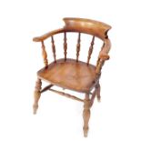 A Victorian beech smoker's bow chair, with solid saddle seat, raised on turned legs, united by a