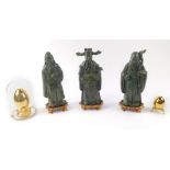 Three 20thC Chinese bronze figures of Taoist Immortals, each raised on a wooden stand, 23cm H,