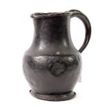 A 19thC dark paternated copper flagon, with a fold over rim, shaped handle, stamped 10S, M. Cope?,