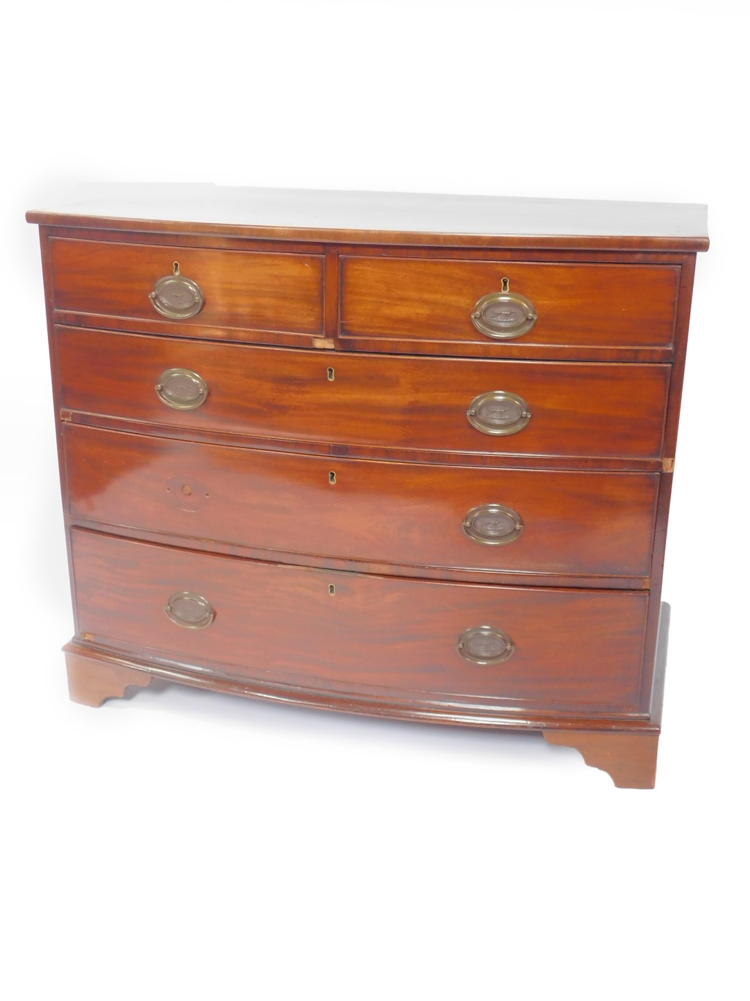 A George III mahogany bow front chest of drawers, of two short over three long drawers, raised on