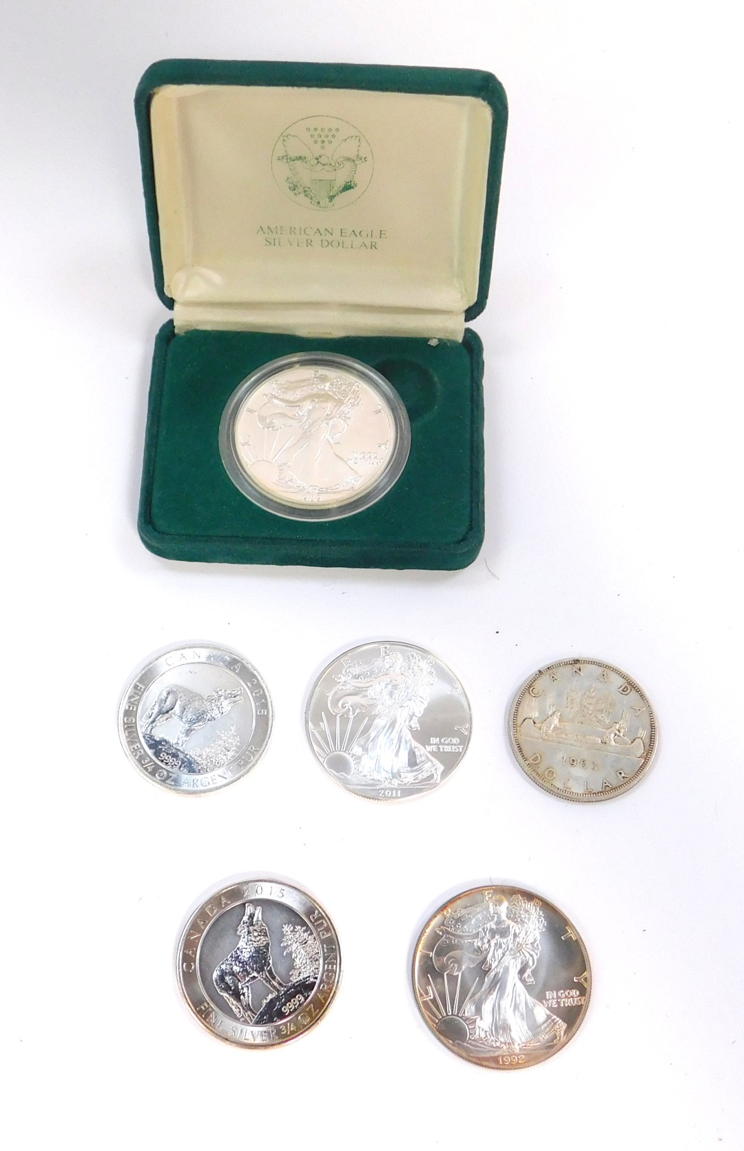 Three American Liberty Eagle silver dollars, 1989, boxed, 1992 and 2011, together with a Canadian